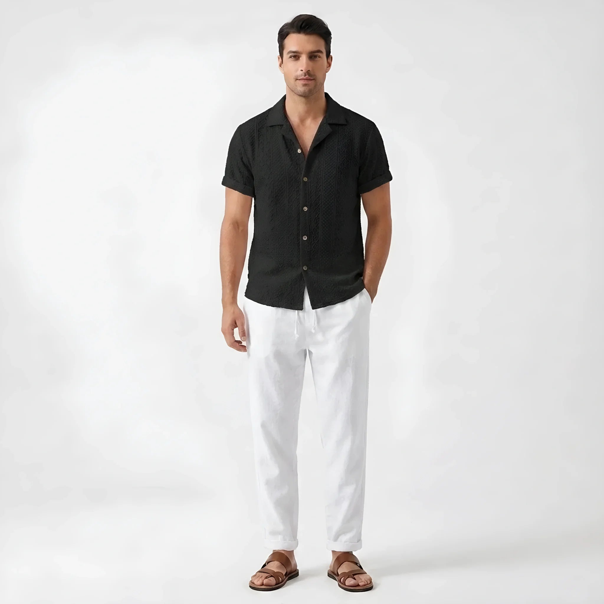 Man in beige floral checkerboard jacquard Cuban shirt and linen pants in outdoor summer lifestyle