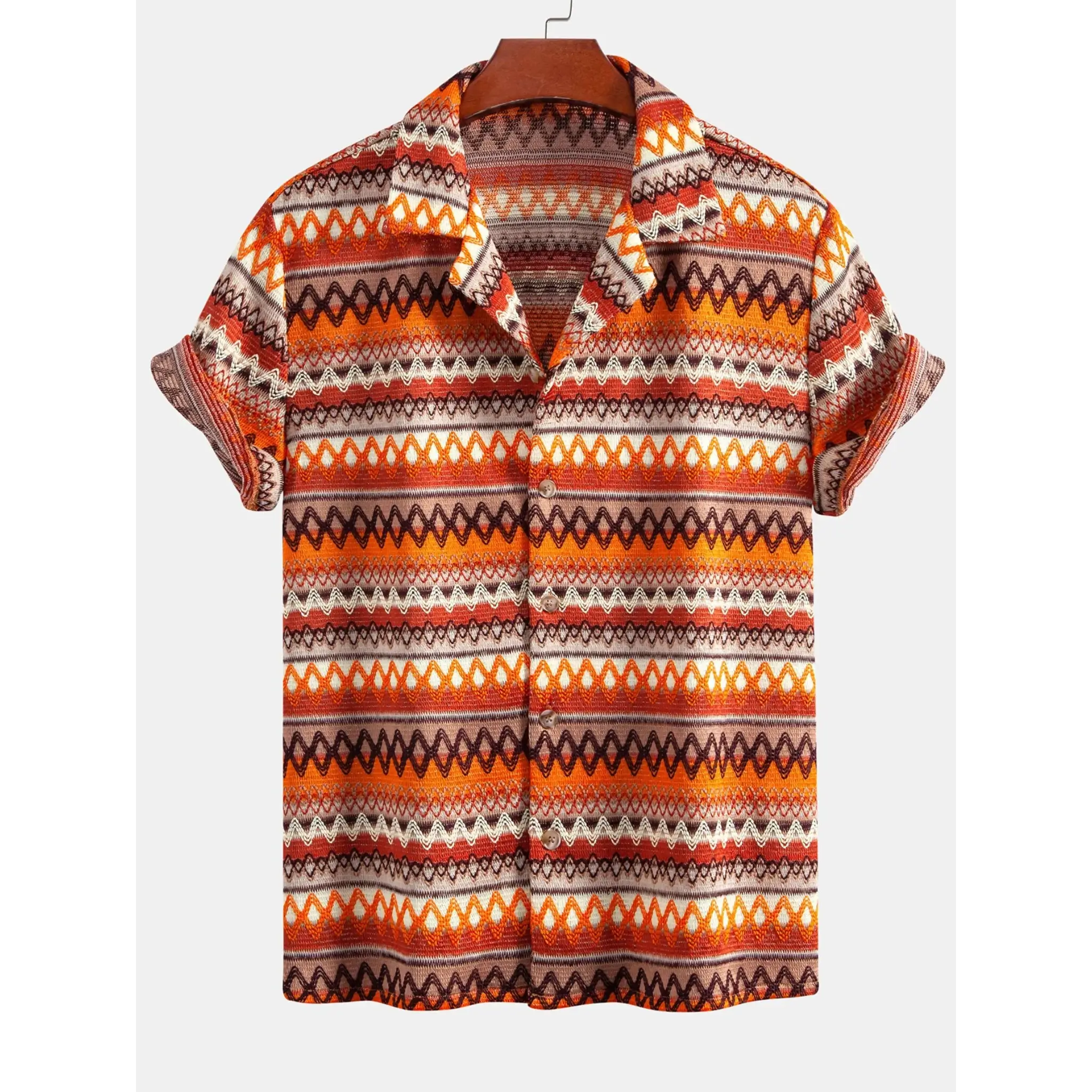 Man in beige geometric Cuban shirt and linen pants walking in sunny outdoor summer scene