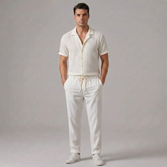 Man wearing beige jacquard Cuban collar shirt and crinkle textured straight leg pants front view