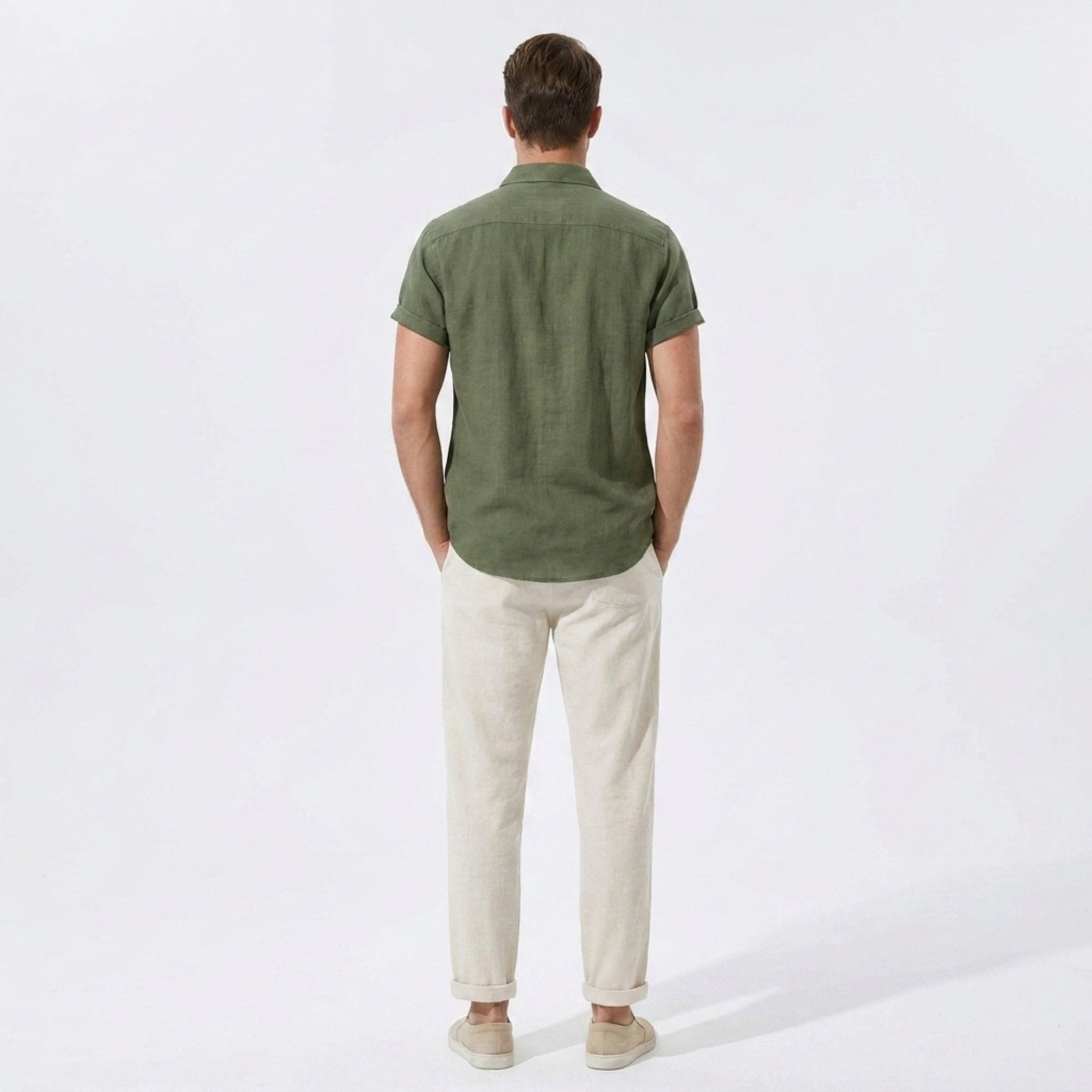 Back view of man wearing beige linen rayon blend utility shirt and straight leg linen pants