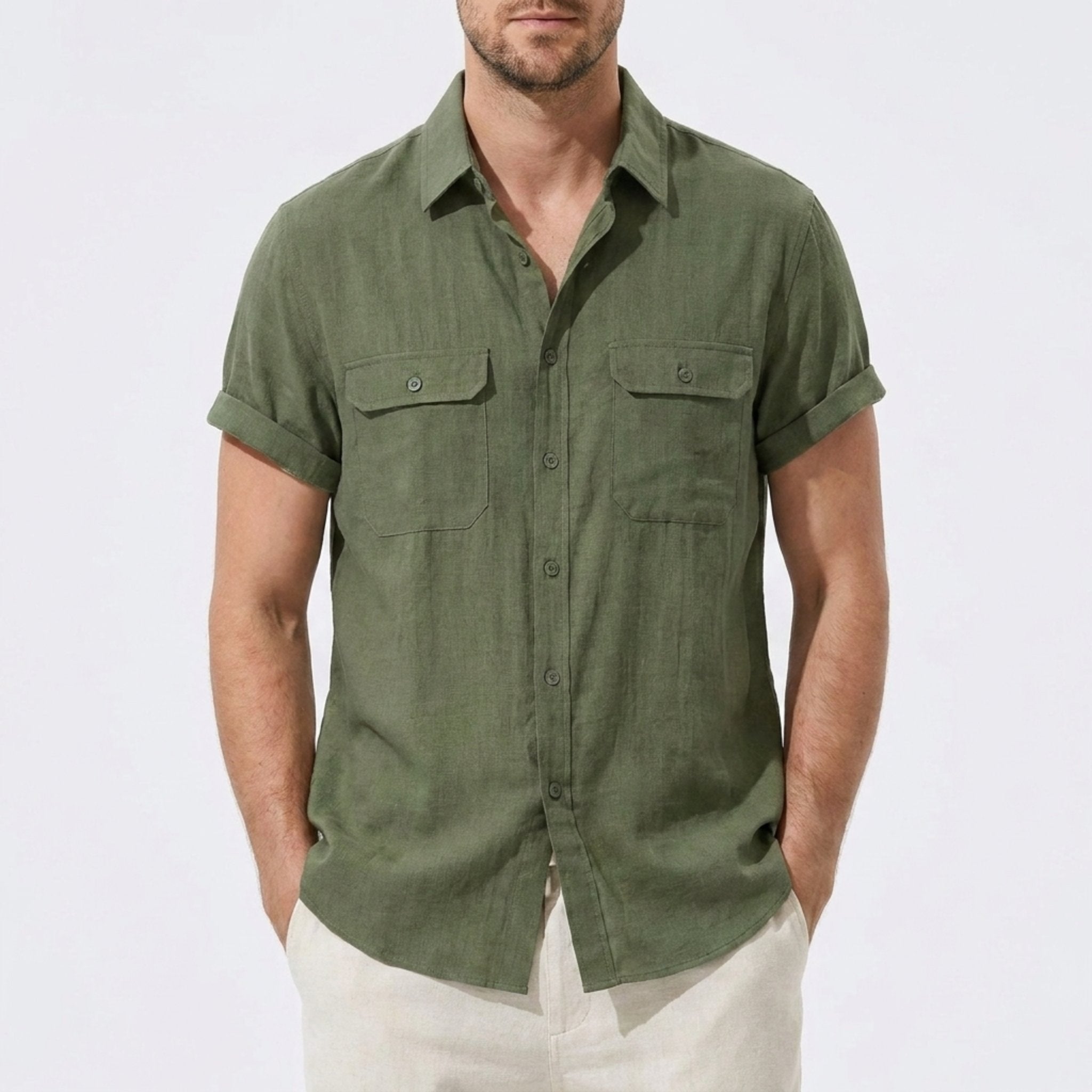 Three quarter view of man in beige linen rayon blend utility shirt and linen pants on plain background