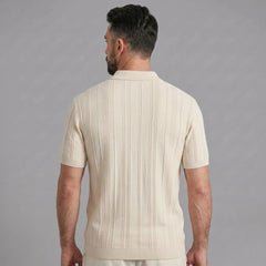Side view of man in beige stripe jacquard knit zip-up polo shirt on plain background