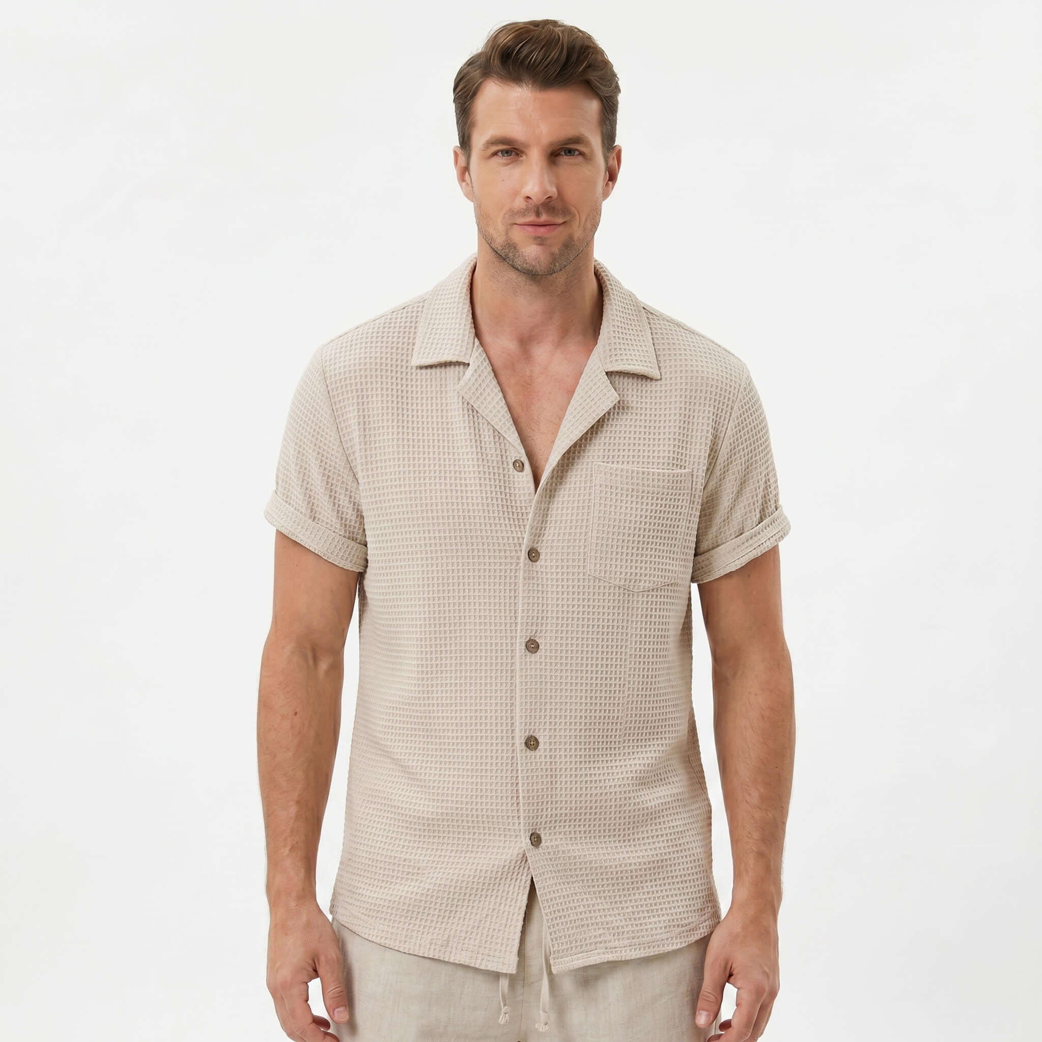 Back view of man wearing beige textured Cuban shirt and linen cotton drawstring shorts