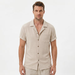 Back view of man wearing beige textured Cuban shirt and linen cotton drawstring shorts
