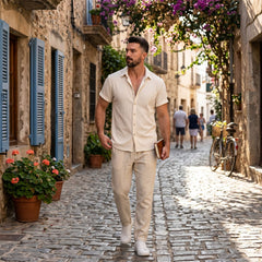 Man in beige waffle shirt and linen pants in sunny outdoor summer scene