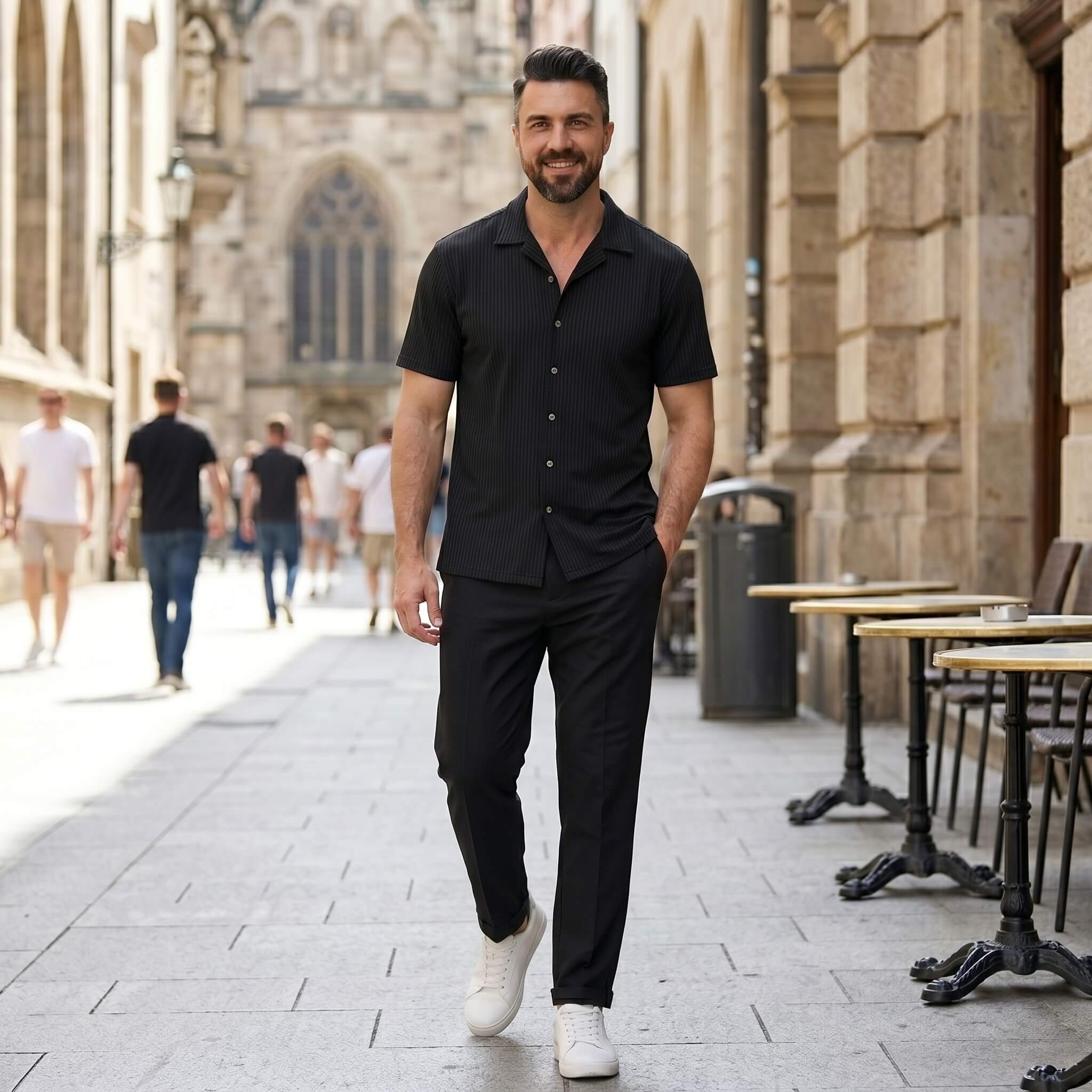 Man wearing beige waffle button up shirt and linen pants walking in outdoor setting
