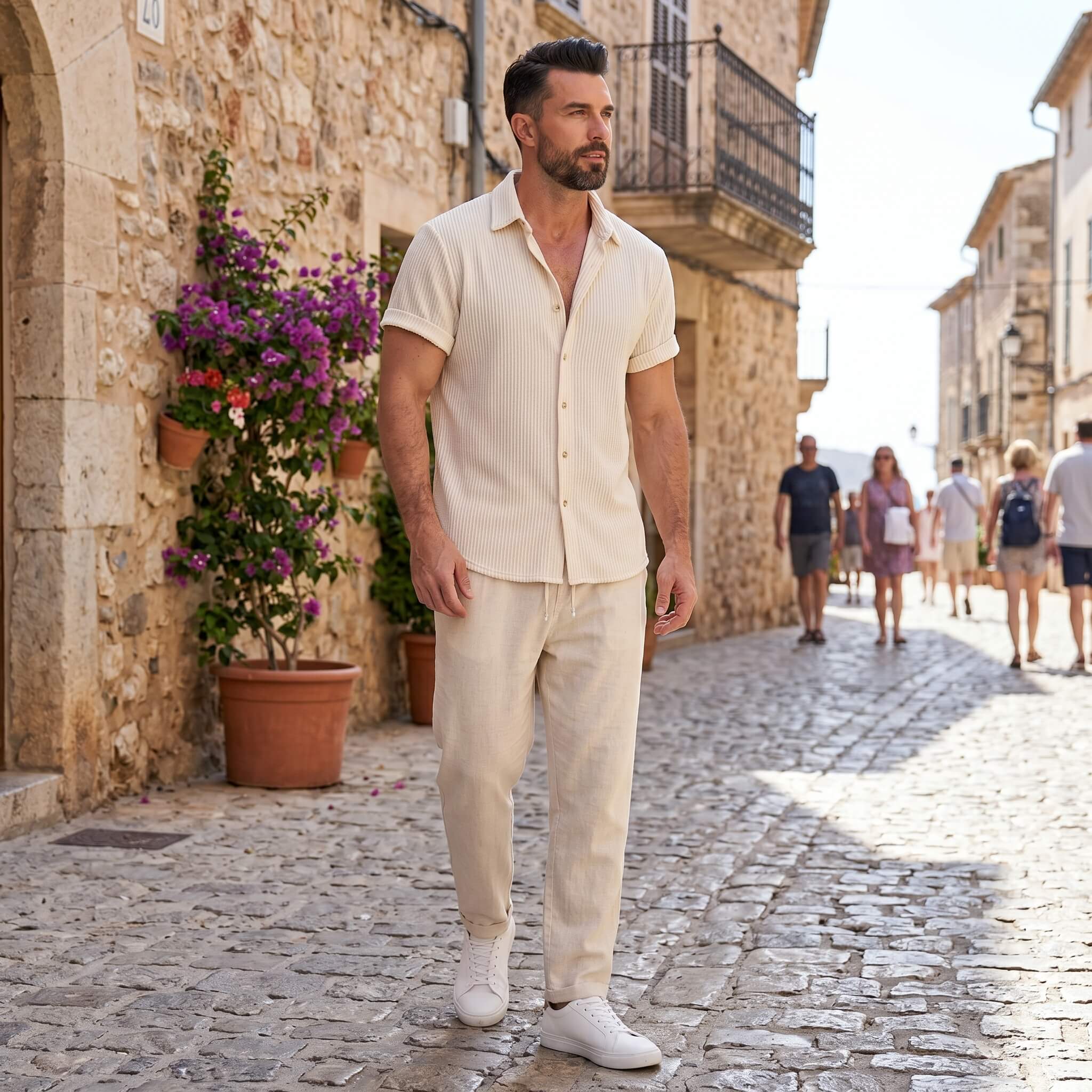 Man wearing a beige waffle button up shirt and straight leg linen pants front view on plain background