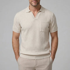 Back view of man wearing beige waffle johnny collar polo shirt and slim fit tapered pants