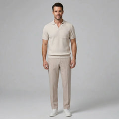 Man wearing a beige waffle johnny collar polo shirt and slim fit tapered pants front view on plain background