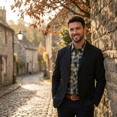 MannerCo black washed cotton casual blazer jacket worn outdoors on cobblestone village street