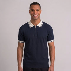 Side view of man in black color block knit polo shirt with lapel collar