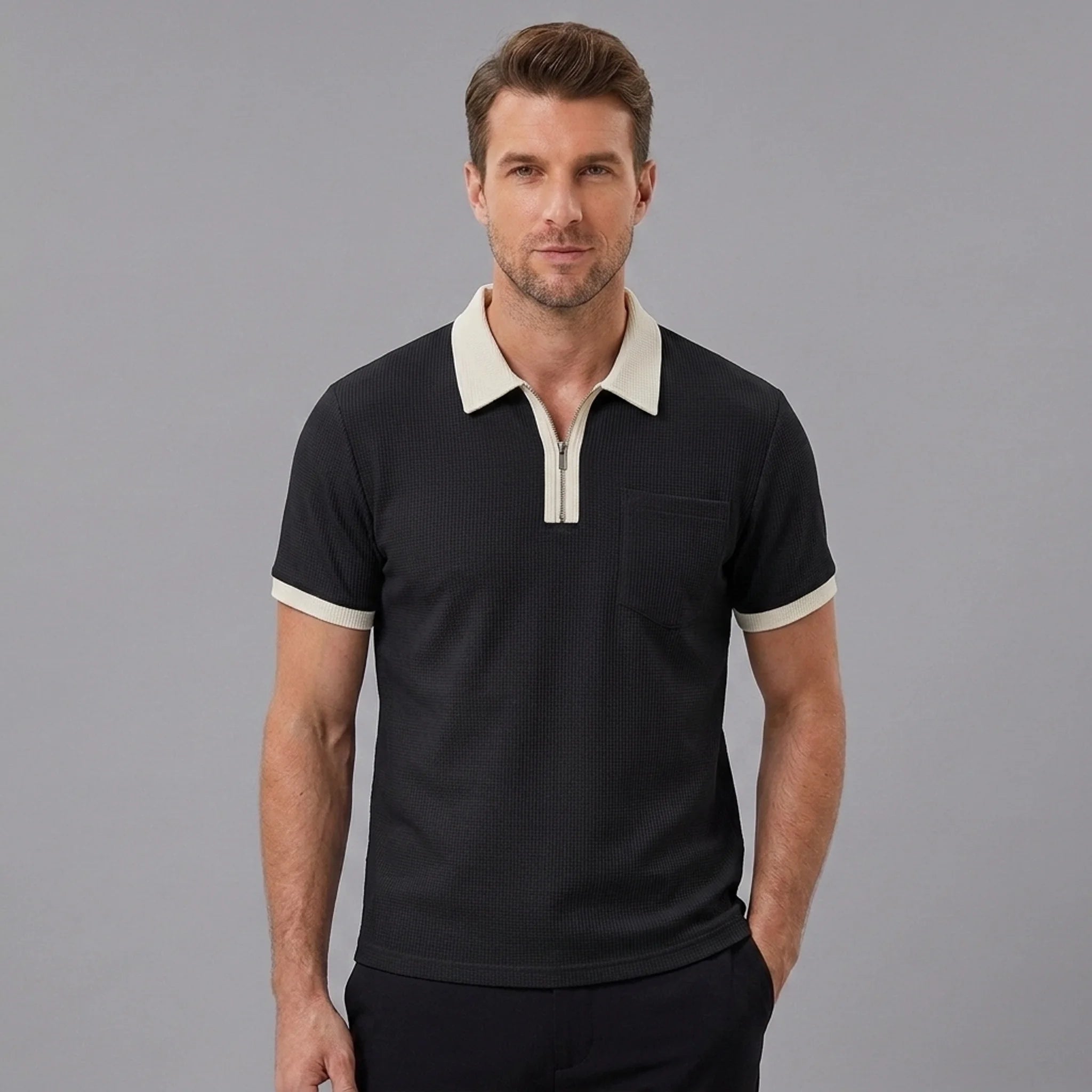 Side view of man in black color block waffle polo shirt on plain background