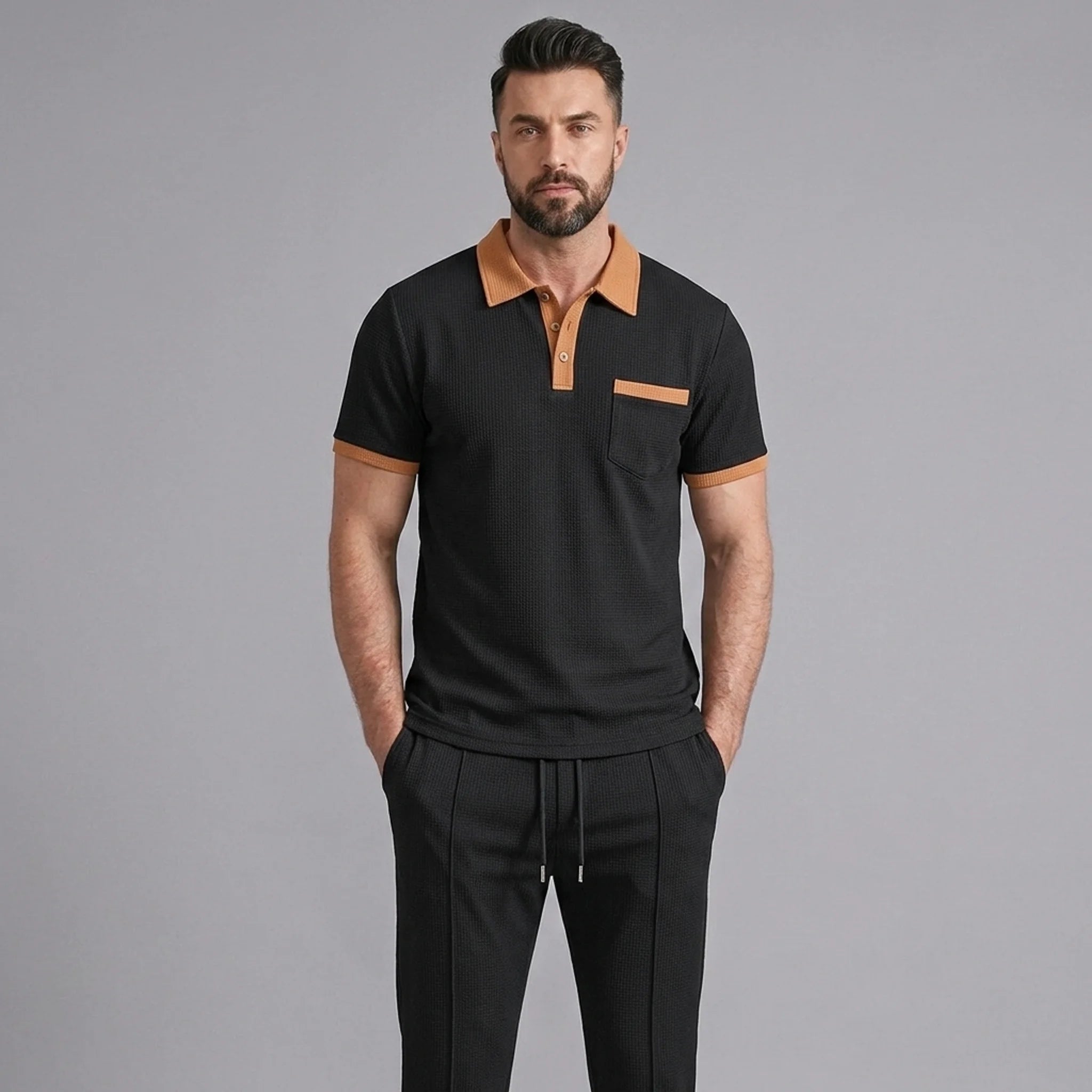 Man wearing a black color block waffle polo and straight leg pants front view