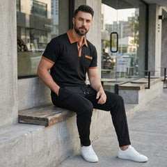 Man wearing black color block waffle polo and straight leg pants in outdoor lifestyle setting
