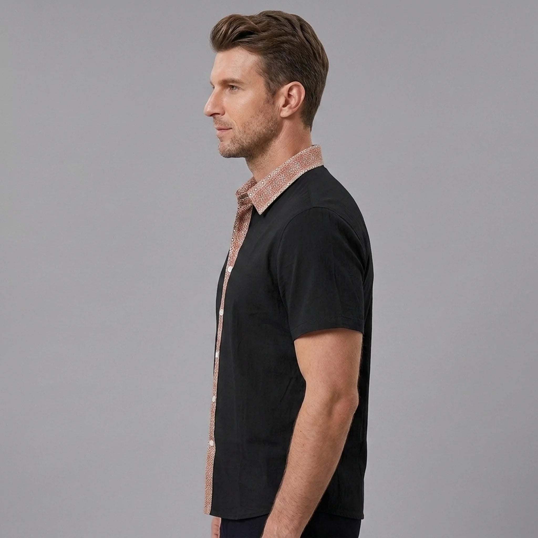 MannerCo black linen blend short sleeve shirt with contrast floral collar, side view on male model