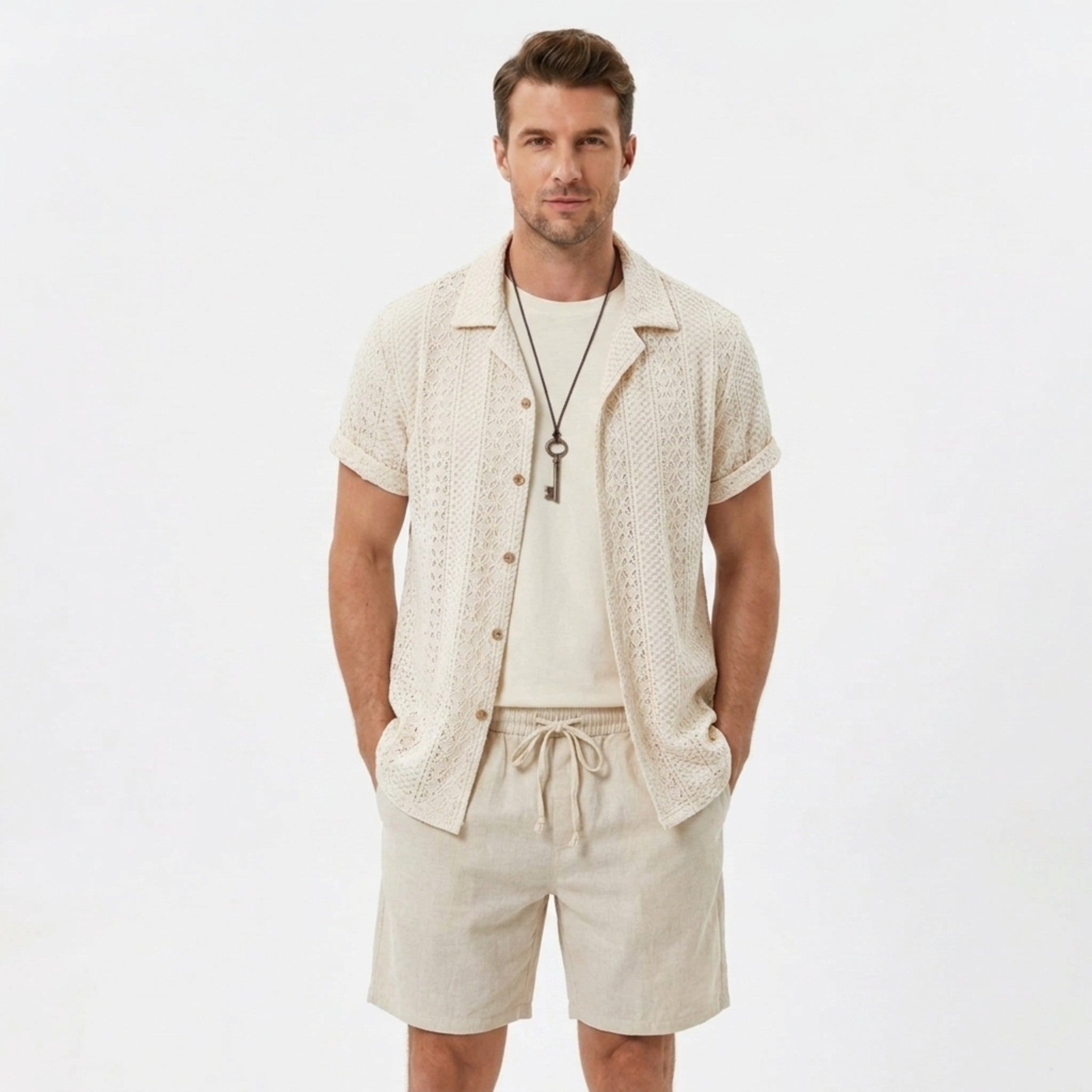 Back view of man wearing black floral checkerboard jacquard Cuban shirt and linen drawstring shorts