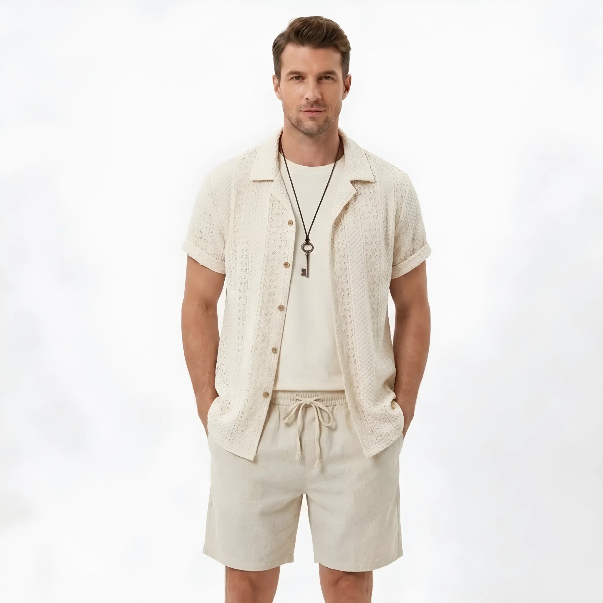 Back view of man wearing black floral checkerboard jacquard Cuban shirt and linen drawstring shorts