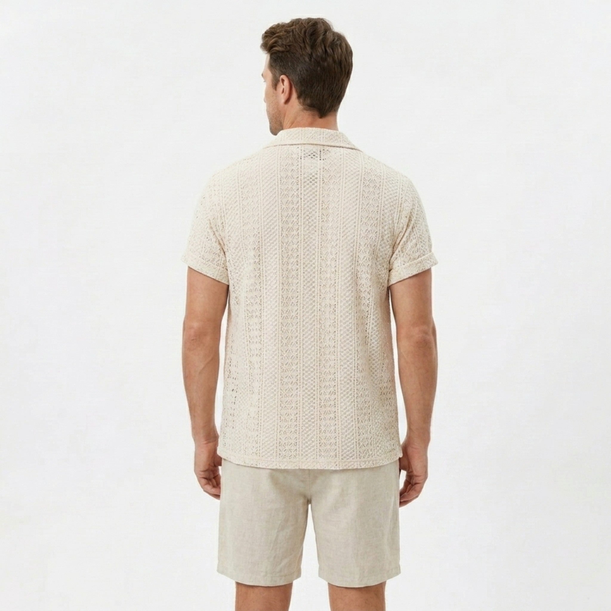 Man wearing black floral checkerboard jacquard Cuban shirt and linen cotton drawstring shorts front view