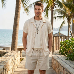 Man wearing black floral checkerboard jacquard Cuban shirt and linen drawstring shorts in outdoor lifestyle