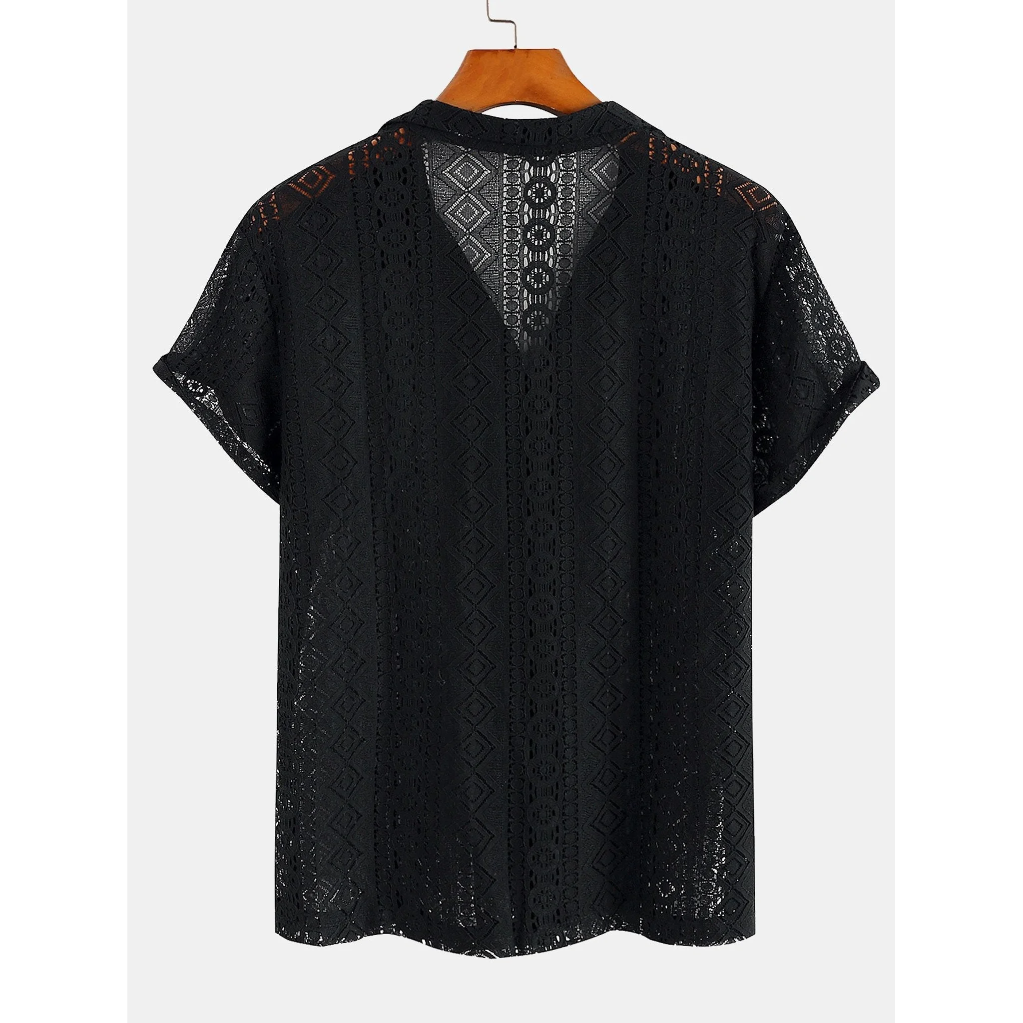 Man wearing black geometry textured Cuban shirt and linen pants in resort outdoor lifestyle scene