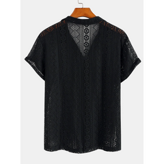 Man wearing black geometry textured Cuban shirt and linen pants in resort outdoor lifestyle scene