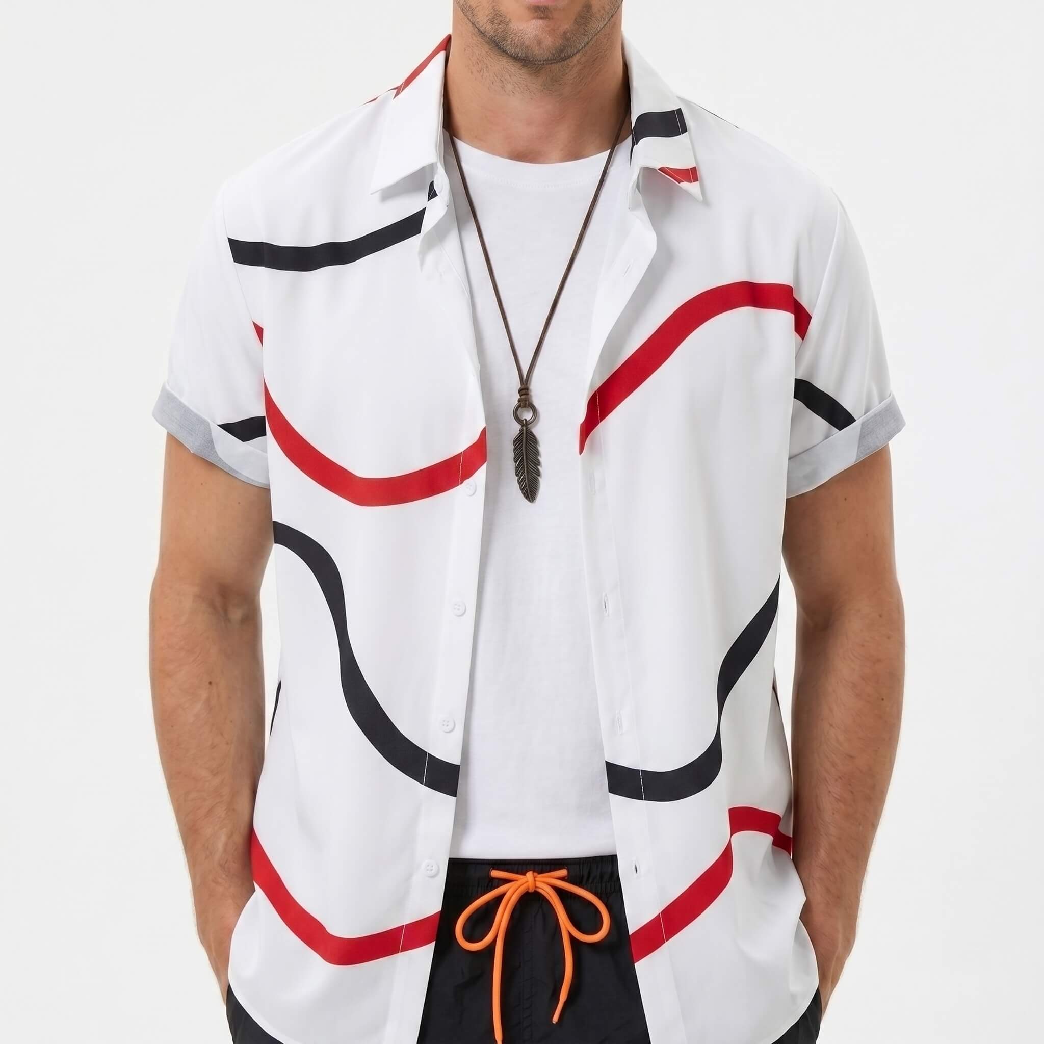 Three quarter view of man in black line print shirt and swim shorts on plain background