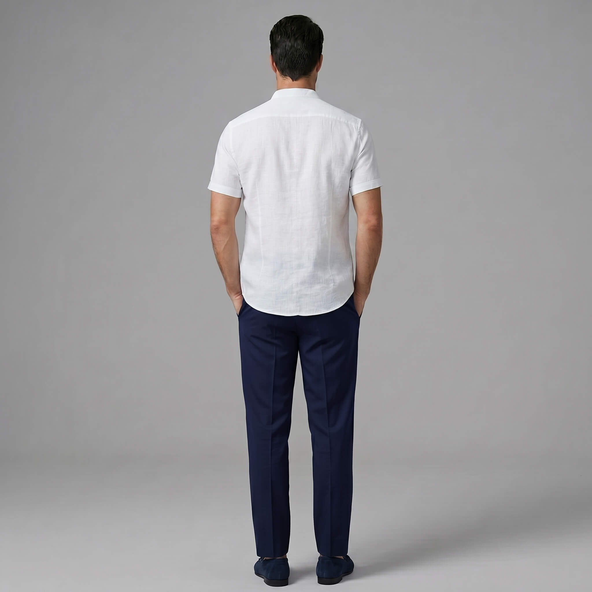 Back view of man wearing black linen look stand collar shirt and slim fit tapered trousers