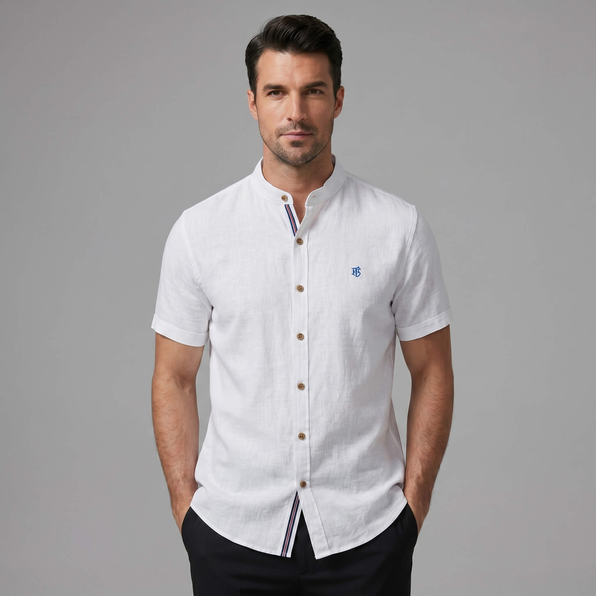 Man in black linen look stand collar shirt and tapered trousers in lifestyle outdoor scene