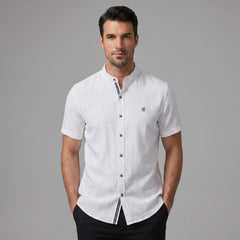 Man in black linen look stand collar shirt and tapered trousers in lifestyle outdoor scene