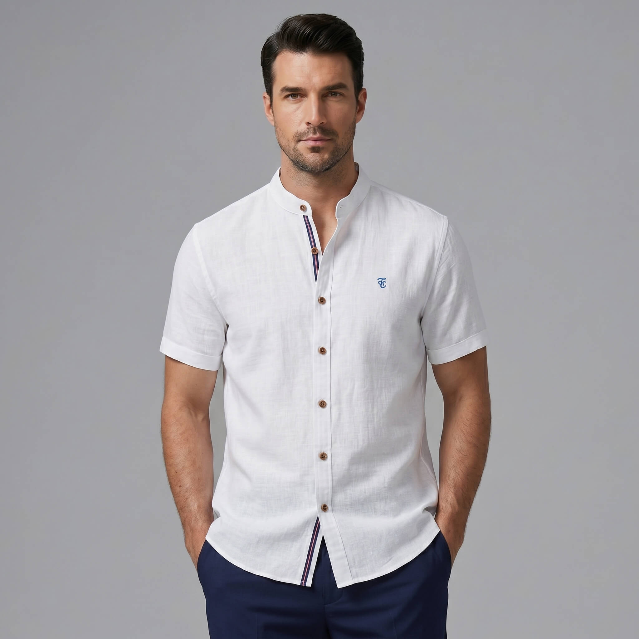 Man wearing black linen look stand collar shirt and slim tapered trousers in outdoor lifestyle setting