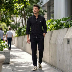 MannerCo black linen stand collar shirt and slim tapered trousers 2-piece set worn outdoors