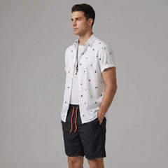 Back view of man wearing black palm tree anchor sailboat print shirt and swim shorts