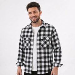 MannerCo black plaid flannel shirt with turn-down collar and chest pockets worn open over white tee
