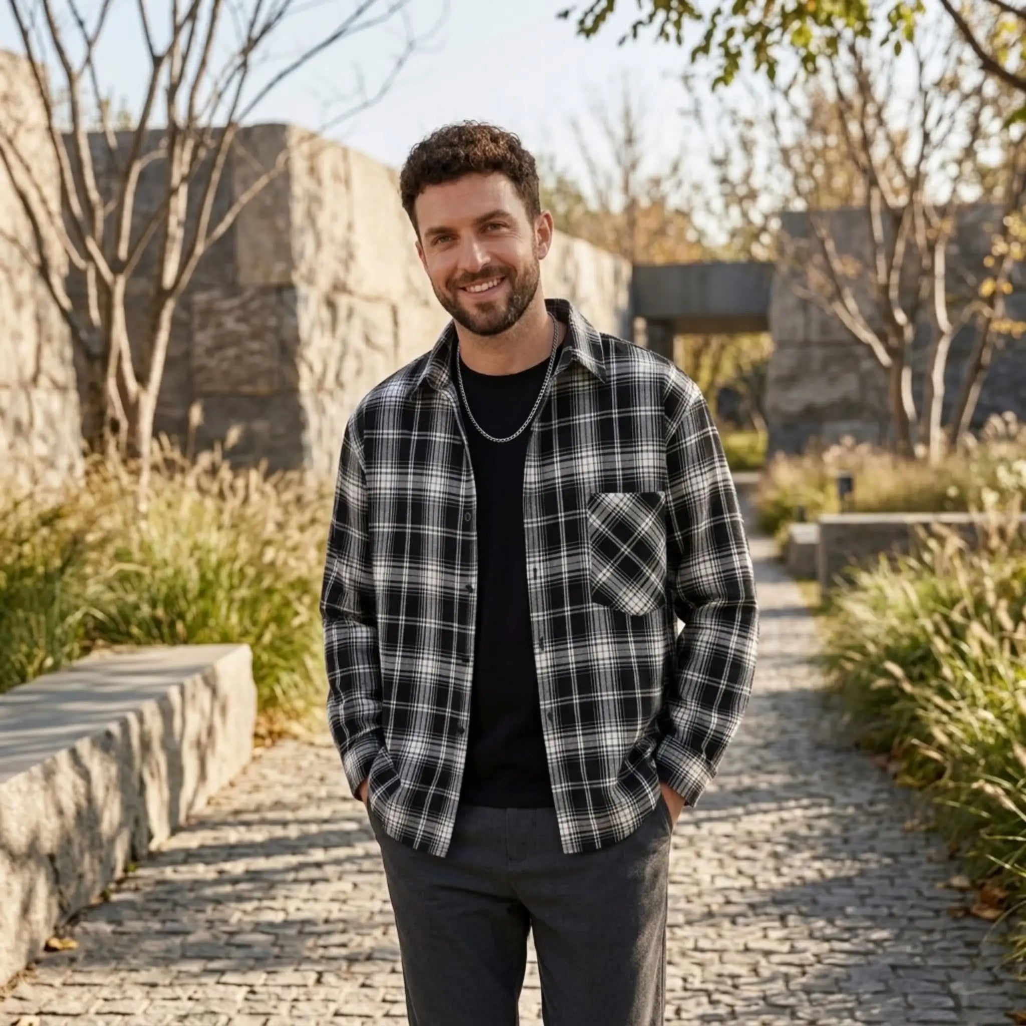 MannerCo black plaid lapel shirt with relaxed fit worn outdoors on cobblestone path