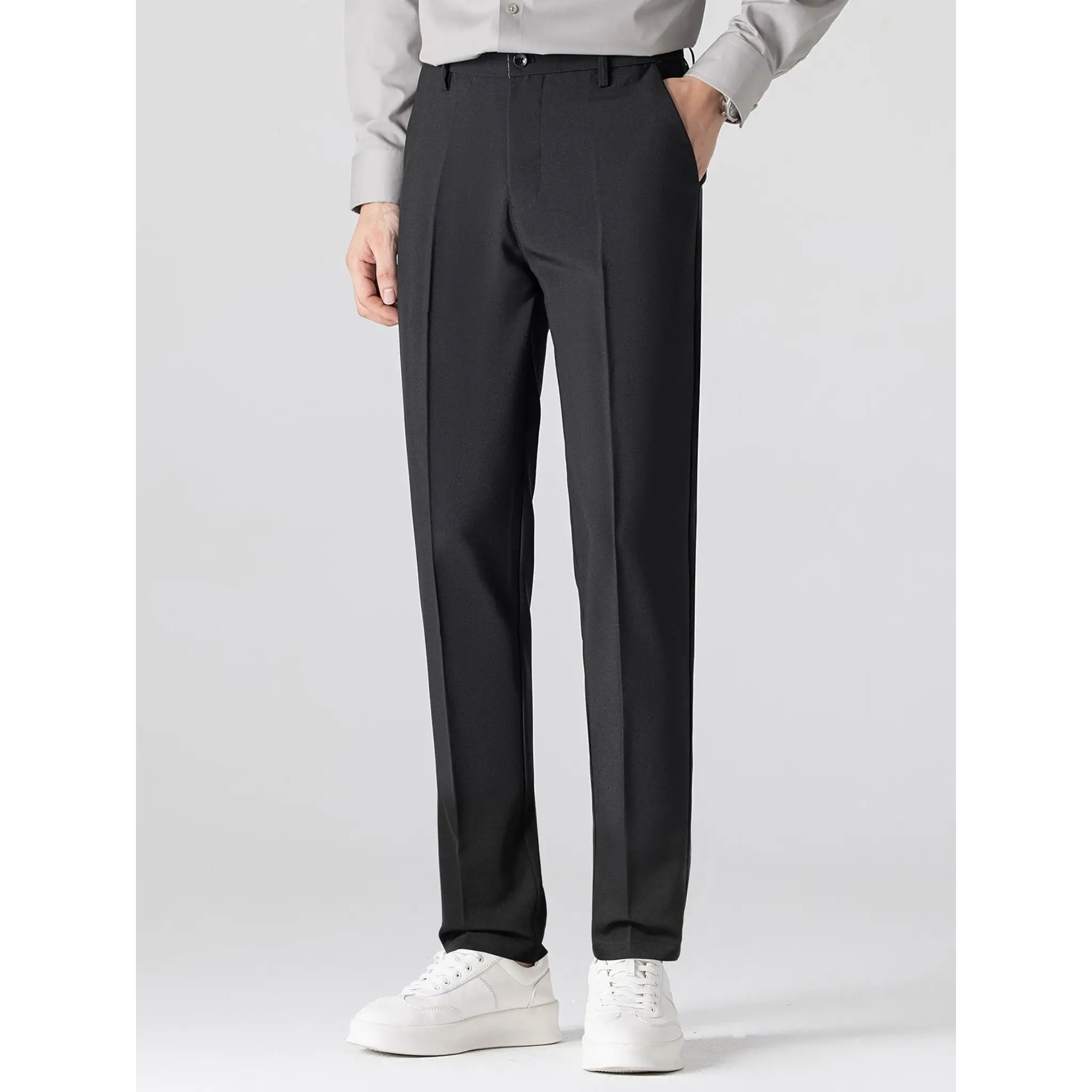 MannerCo black slim fit tapered trousers front view with white sneakers