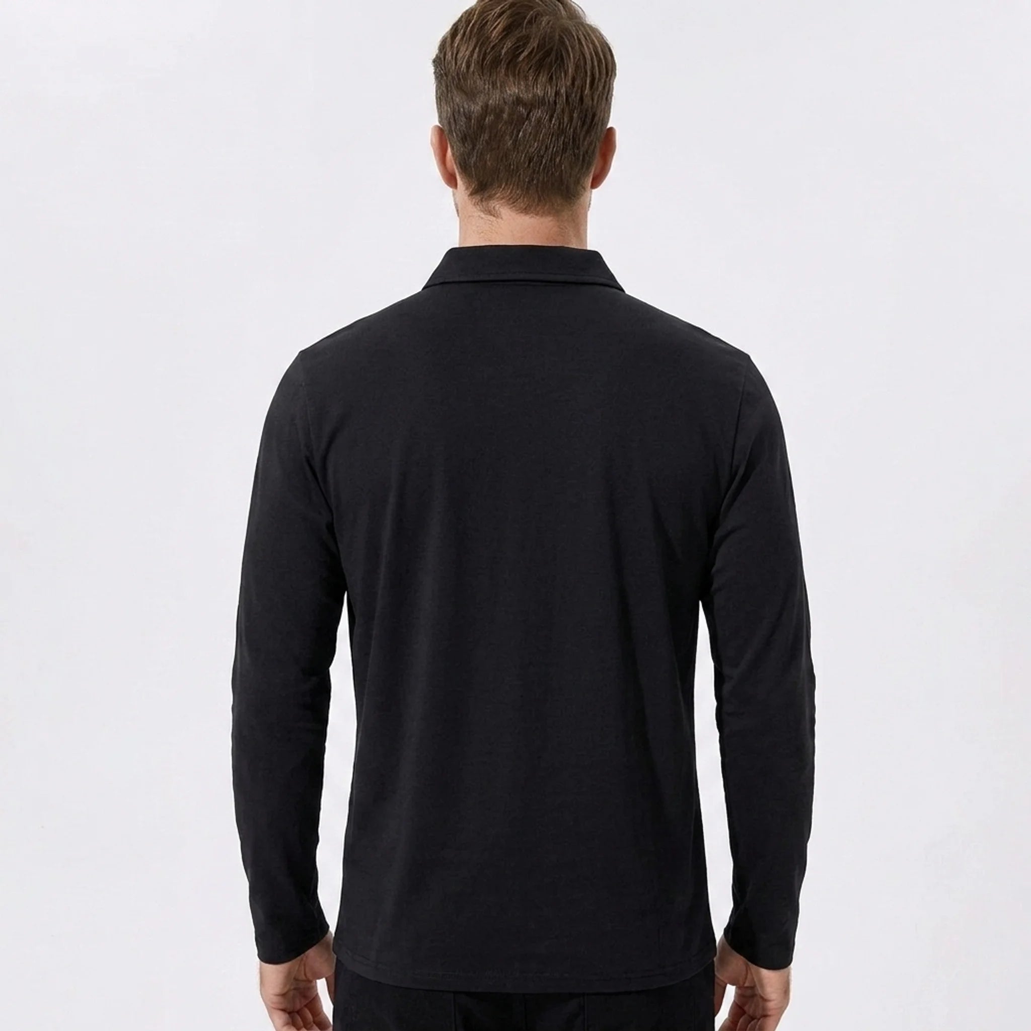 Man wearing black solid long sleeve cotton polo shirt, back view on neutral background