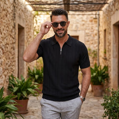 Man wearing black stripe jacquard knit zip-up polo shirt in outdoor lifestyle setting