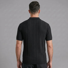 Side view of man in black stripe jacquard knit zip-up polo shirt on plain background