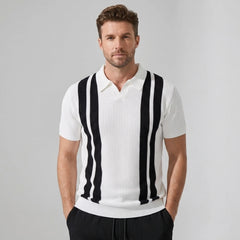 Man wearing a white polo shirt with black vertical stripes on a gray background
