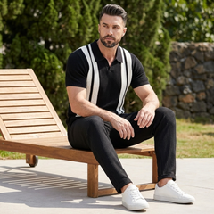 Full length view of man wearing black striped knit polo and waffle drawstring pants