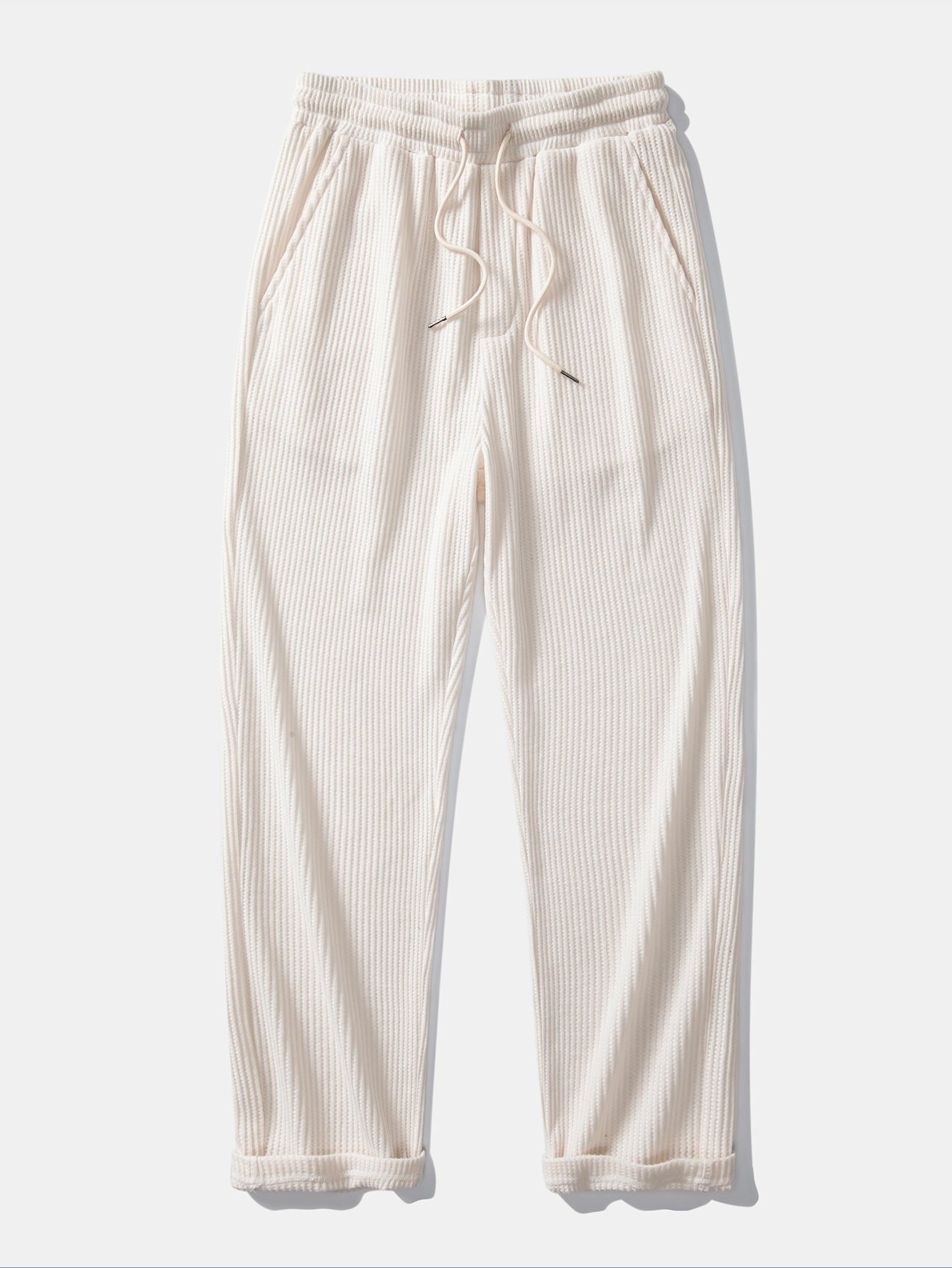 Side view of man in black striped knit Johnny collar polo and waffle drawstring pants