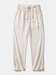 Side view of man in black striped knit Johnny collar polo and waffle drawstring pants