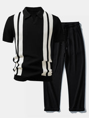 Man wearing black striped knit Johnny collar polo and waffle drawstring pants relaxed outdoor pose