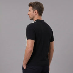 Back view of man wearing black striped knit slim fit polo shirt