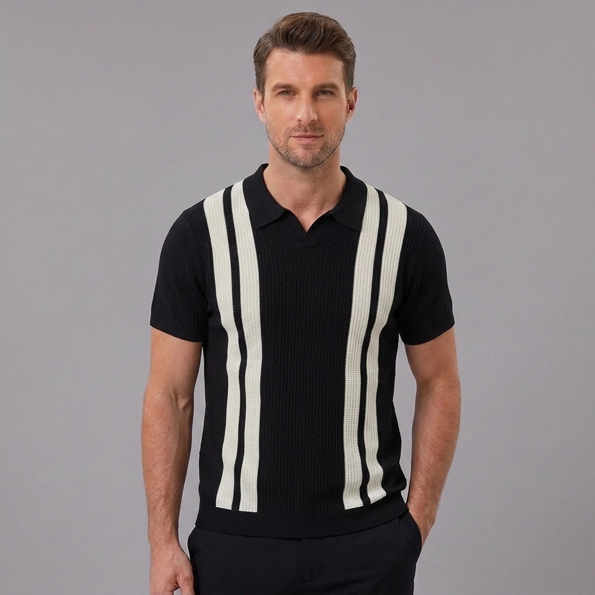 Man wearing a black striped knit slim fit polo shirt front view on plain background