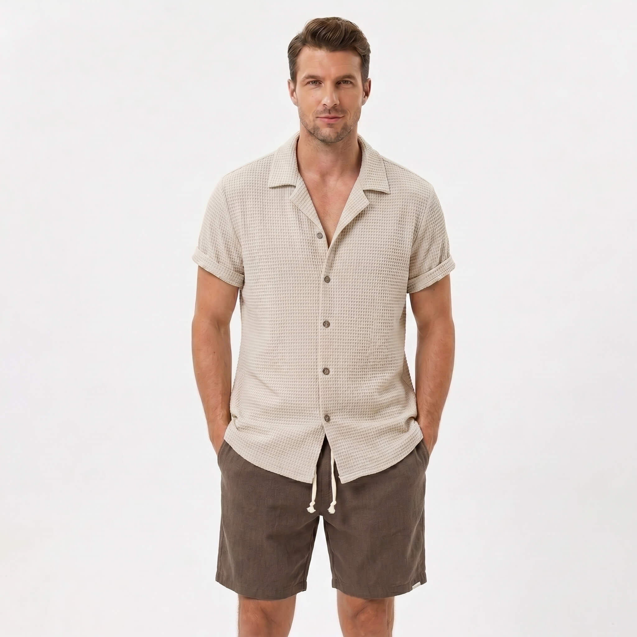 Back view of man wearing black textured Cuban shirt and linen cotton drawstring shorts