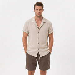 Back view of man wearing black textured Cuban shirt and linen cotton drawstring shorts