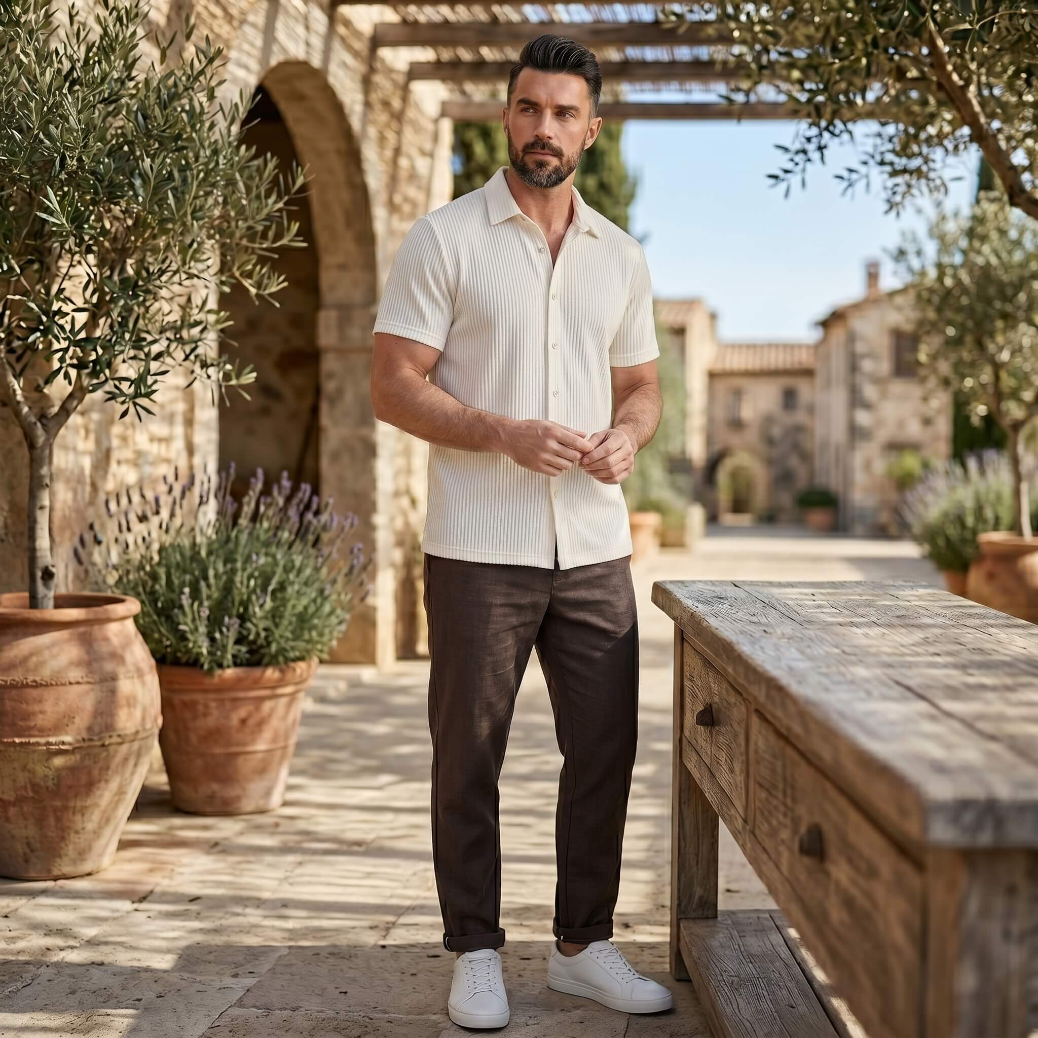 Man wearing black waffle button up shirt and linen pants in outdoor lifestyle setting