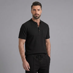 Man wearing a black waffle stand collar button up shirt and drawstring shorts front view on plain background