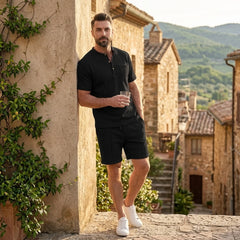 Man wearing black waffle stand collar shirt and drawstring shorts in outdoor lifestyle setting